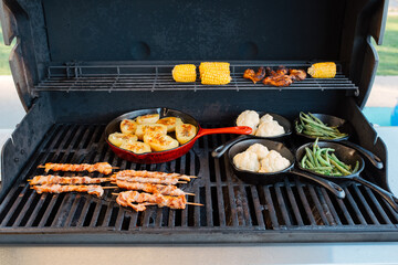 preparing dinner on a gas grill