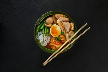 Traditional Japanese soup with meat broth, asian rice noodles, sliced chiken, eggs. Close up. Asian...