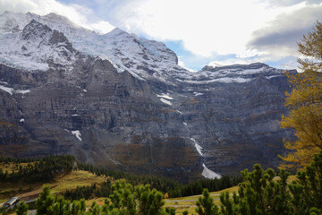 View of snow alp mountain landscape in autumn nature at swiss from the train