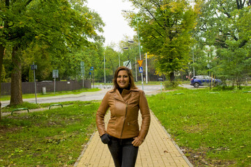 happy woman walking in the park in wroclaw, poland 
