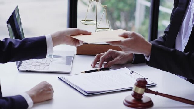 Concepts of corruption, bankruptcy courts, bail, crime, bribery, fraud, Judge Gavel, soundboard, and a handful of cash on the table.