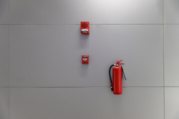 Dry chemical powder fire extinguisher in corridor. Install a fire extinguisher on the wall in...