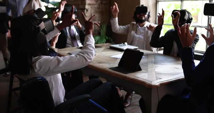 Diverse business people wearing virtual reality goggles inside office 