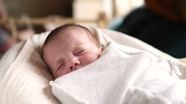 little girl newborn sleeping. portrait baby close-up a sleeping in bed indoors. maternity hospital continuation of the family concept. newborn baby sleeping face cute portrait lifestyle
