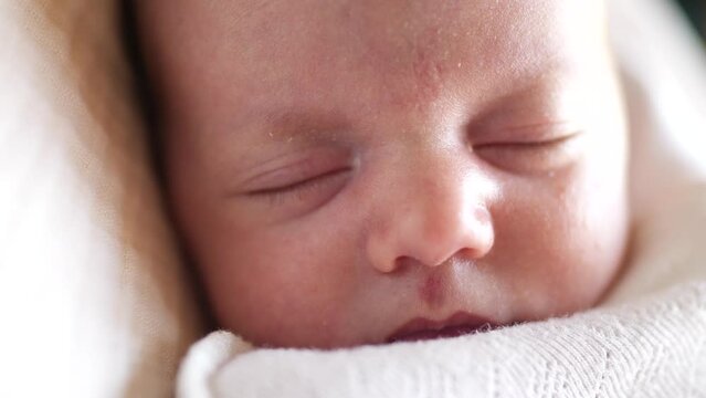 little girl newborn sleeping. portrait a baby close-up sleeping in bed indoors. maternity hospital continuation of lifestyle the family concept. newborn baby sleeping face cute portrait