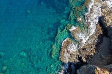 Aerial view Sea top big wave crashing on rock wall Beautiful dark sea surface in sunny summer background