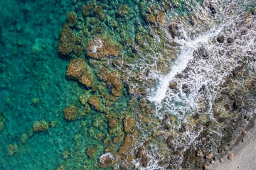 Aerial view Sea top big wave crashing on rock wall Beautiful dark sea surface in sunny summer background