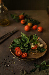 Caprese salad in a Glass for Serving in a Ceramic Plate and the Ingredients for It. Italian cuisine. 