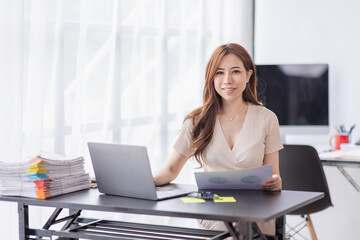 freelance Accounting Asian businesswomen doing calculating income-expenditure and analyzing real estate investment data, Financial and tax systems concept.
