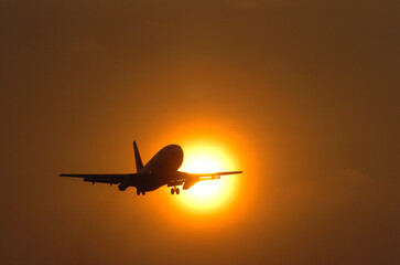 The plane will land when the sun sets on the western horizon