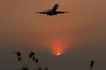 The plane will land when the sun sets on the western horizon