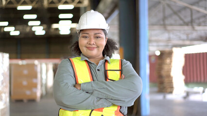 Happy - cheerful Asian woman engineer crossing arms and looking at camera. 