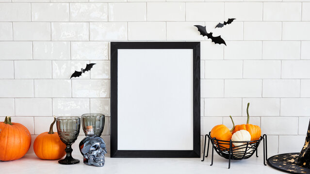 Scandinavian living room interior with Halloween decor and picture frame mockup. Halloween holiday celebration concept.
