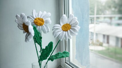 knitted white flower on the windowsill