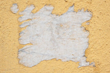 Street wall with remnants of a paper ad