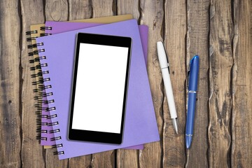 Blank screen smartphone with notebooks on the desk