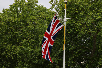 Union Jack flies on the boulevard of Buckingham Palace, London