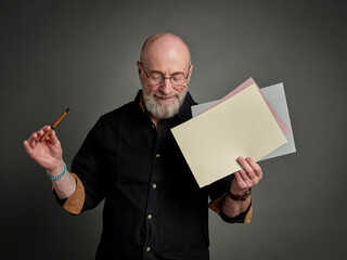 portrait of senior man, teacher, mentor or presenter, with blank sheets of paper and pen, education...