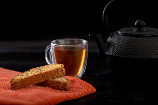 cup of tea and teapot and biscotti