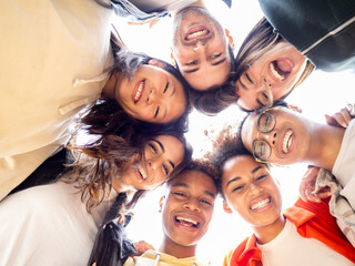 Best friends having fun concept multiethnic teen friends group looking down