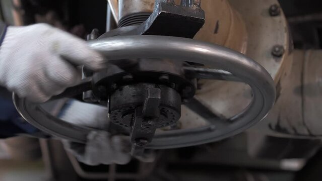 Gas industry worker turns large valve