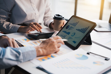 Teamwork with business people analysis cost graph on desk at meeting room, teamwork concept.