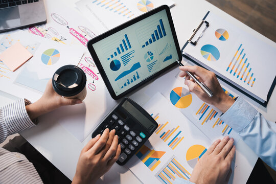 Teamwork with business people analysis cost graph on desk at meeting room, teamwork concept.