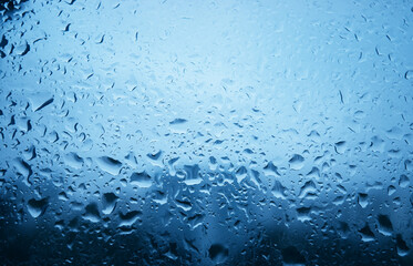 Raindrops on glass window texture backdrop