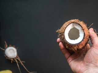 coconut on blackboard coconut on hand nut