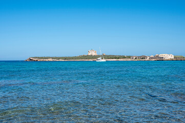 Fototapeta premium The island of Capo Passero in front of Portopalo where the waters of the two seas divide, the Ionian Sea and the Mediterranean Sea