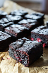 Pieces of homemade chocolate brownie with cherries. Delicious summer dessert. Selective focus. Hard lighting - 535561484