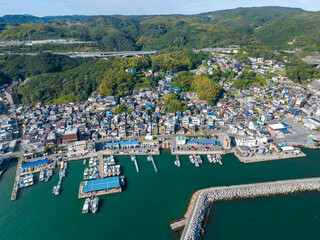 Fototapeta na wymiar Aerial view of small coastal village and harbor on sunny day