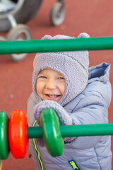 Fototapeta na wymiar Adorable little toddler boy having fun on playground outdoors