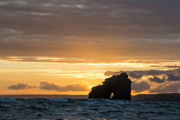 Thurlestone Rock silhouetted against the sunset on September 9th 2022 in Thurlestone, Devon, UK.