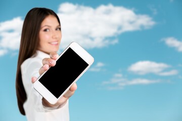 Beautiful woman holding blank screen smartphone