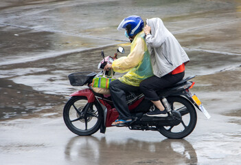 Mototaxi is driving with a passenger in heavy rain