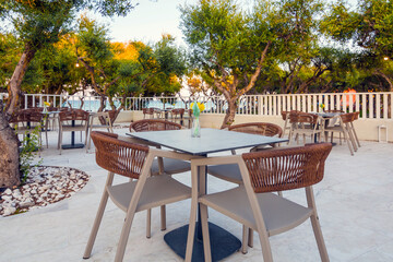 Tables in restaurant on the terrace . Zakynthos, Greece. Superb summer mood, outdoor restaurant. Romantic vibes, summer colors under blue sky