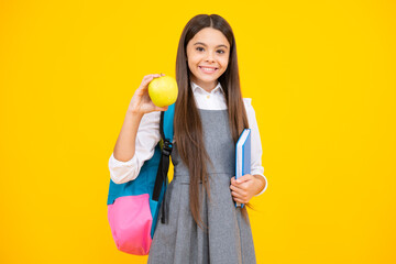 Schoolchild, teenage student girl hold book on yellow isolated studio background. School and education concept. Back to school.