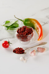 Spicy seasoning of Georgian cuisine adjika in a glass bowl