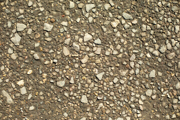 Small stone on road. Lots of stones.