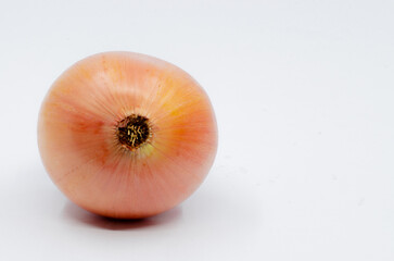 Orange colored onion. Onion prepared for food. Onion on a white isolated background.

