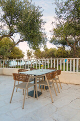 Obraz premium Tables in restaurant on the terrace . Zakynthos, Greece. Superb summer mood, outdoor restaurant. Romantic vibes, summer colors under blue sky