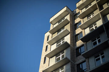 Building with windows. Urban development. Lots of apartment building.