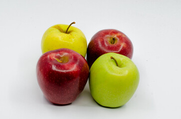 Red and Green colored Apples in a blue colored plate. Red and green apples isolated on a white background.
