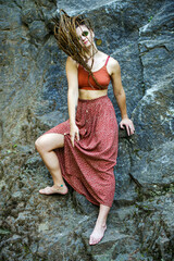 Beautiful girl with dreadlocks, dressed hippie style,poses outdoors.