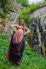 Fototapeta na wymiar Beautiful girl with dreadlocks, dressed hippie style,poses outdoors.
