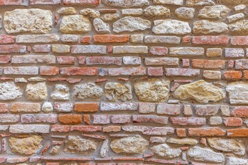 Picture of an old pastel-coloured natural stone wall