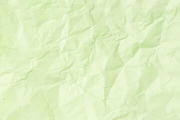 Green crumpled paper background texture. Full frame