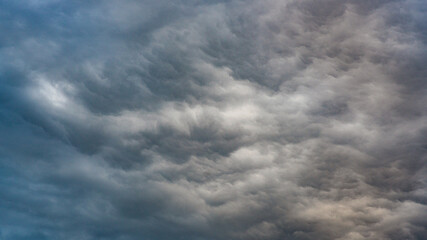 Texture of bright blue dramatic cloudy sky.