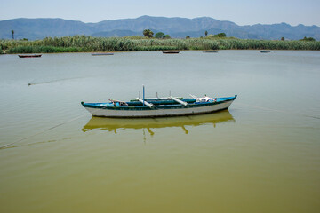 Artisanal fishing boats docked in the Estany Gran area in Cullera, Valencia, Alicante, Spain. surrounded by nature